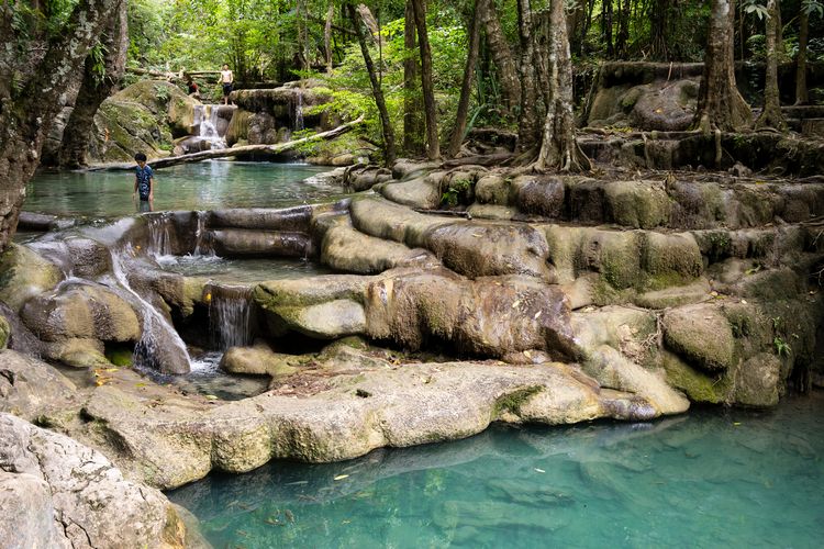 turquoise swimming pools at Erawan Falls in Kanchanaburi Thailand
