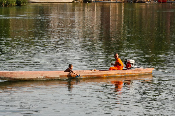 Lao monk in a boat on the Mekong
