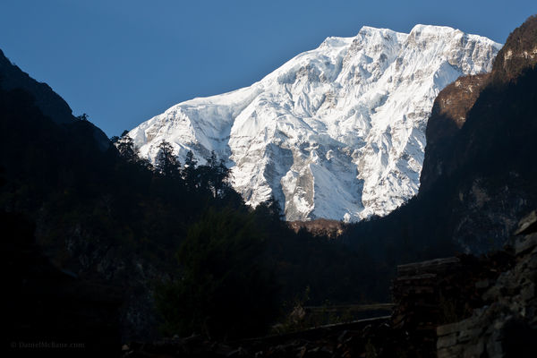 Morning sun illuminates mountain Annapurna Trek