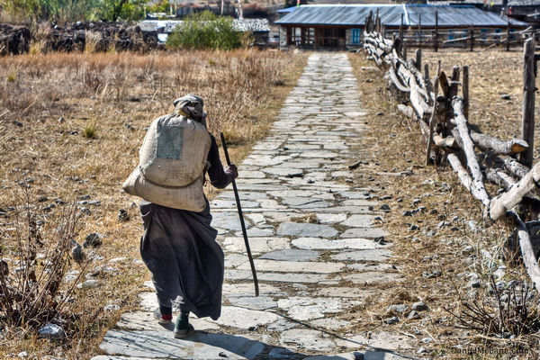 Nepalese woman carrying sack in Pisang, Annapurna