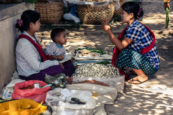 Local woman buying spices in Ywama market, Myanmar