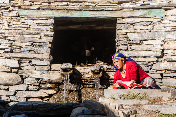 Woman doing laundry in Ngawal, Annapurna, Nepal
