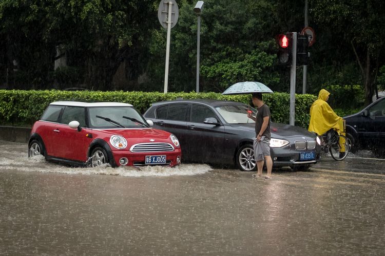 Tiny car on a flooded Shenzhen street